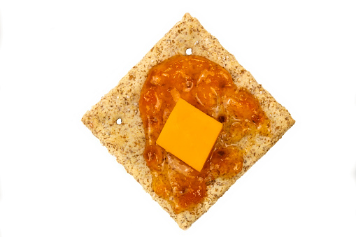 Cracker with peach jam and cheddar cheese