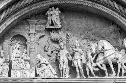 A religious sculpture on the facade of Como Cathedral. Building on this cathedral began in 1396 with architect Lorenzo degli Spazzi from Laino supervising. The church facade was built in the later part of the 15th century and was concluded in 1770.