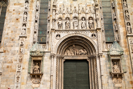 Pliny the Younger (left) and Pliny the Elder (right) on the facade of Como Cathedral. Both were born in Como. Pliny the Elder was killed at Pompeii, which was recorded by Pliny the Younger, who was present but managed to escape. They are in glass cubicles to protect them from smog. Building on this cathedral began in 1396 with architect Lorenzo degli Spazzi from Laino supervising. The church facade was built in the later part of the 15th century and was concluded in 1770.