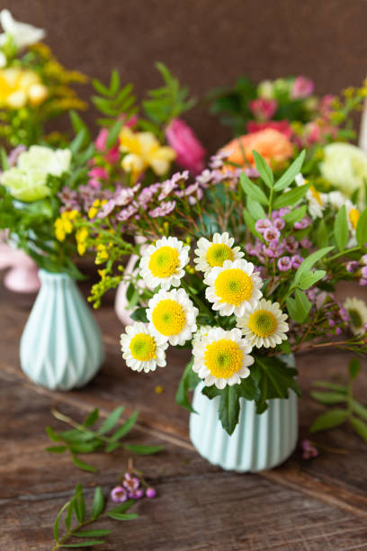 istock Fresh spring flowers in little vases 1305990585