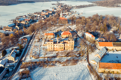 Aerial view of the abandoned ruins of a palace in the village of Stolec. The palace was built in the baroque style in the first half of the 18th century. At the end of the 19th century, the building was expanded, giving it a monumental form in the French neo-baroque style. Southwestern Poland.