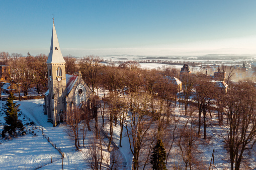 Aerial view of the church and cemetery in the village of Stolec in Lower Silesia in winter, when everything is covered with snow.