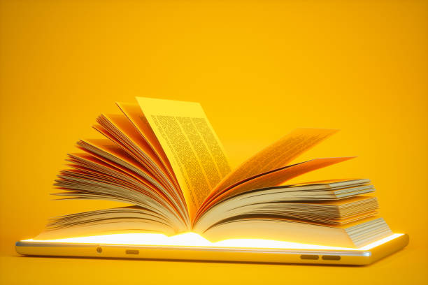 オーディオブックまたはeラーニングコンセプト。黄色の背景を持つデジタルタブレット上のブックを開きます. - textbook ストックフォトと画像
