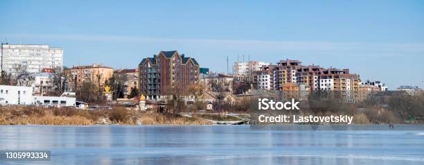 City Landscape Panoramic Shot From The Frozen River On The Banks Of Which New Multistorey Buildings Have Been Erected Stock Photo - Download Image Now