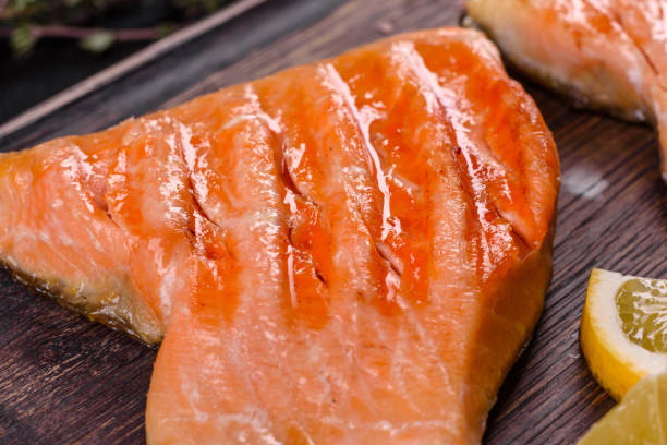 istock Tasty fresh red fish arctic char baked on a grill 1305994618