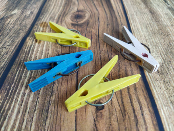 istock Multicolored clothespins on a wooden table 1305996904
