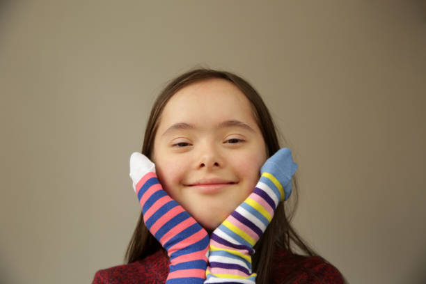 istock Cute smiling down syndrome girl 1305998734