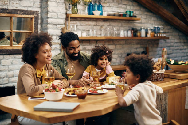 istock Happy African American family relaxing while talking at dining table. 1306001455