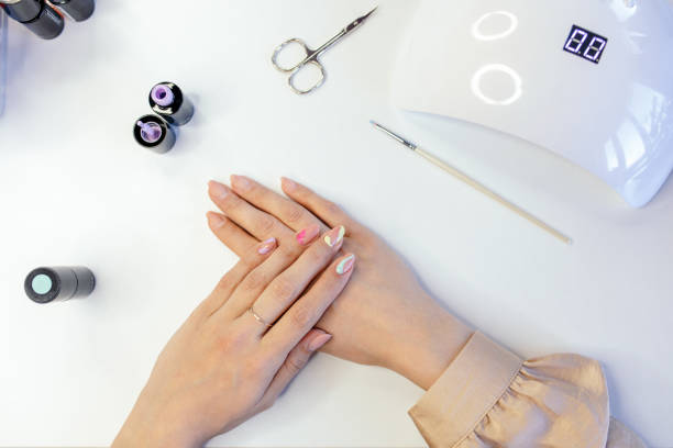 istock Woman doing her own manicure at home 1306002192