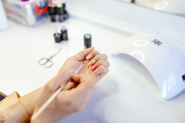 istock Woman doing her own manicure at home 1306002193