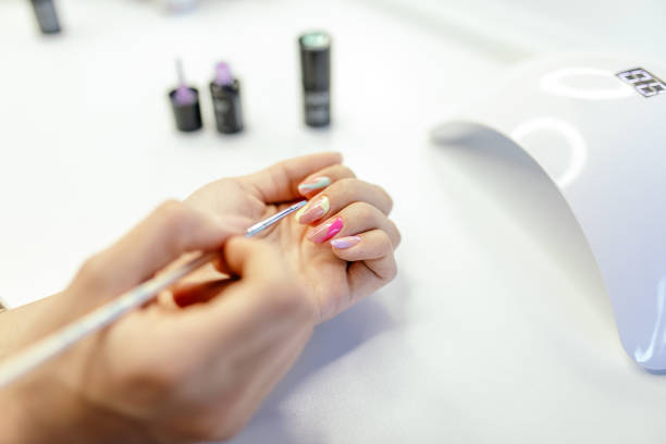 istock Woman doing her own manicure at home 1306002211