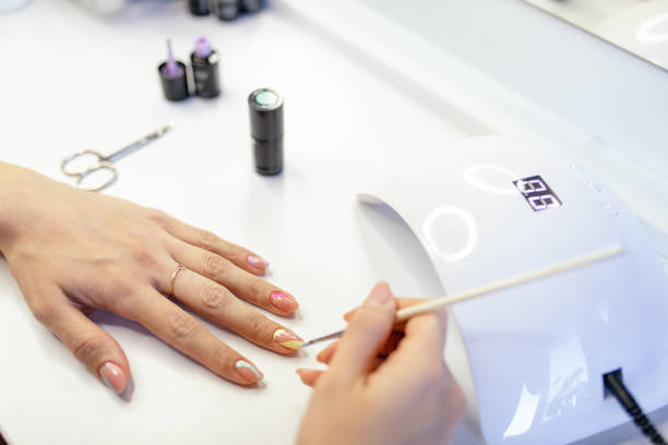 istock Woman doing her own manicure at home 1306003666