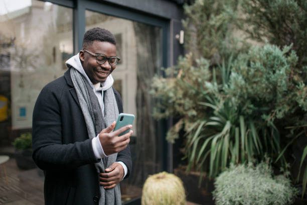 istock Happy African American young man using a smart phone 1306004779