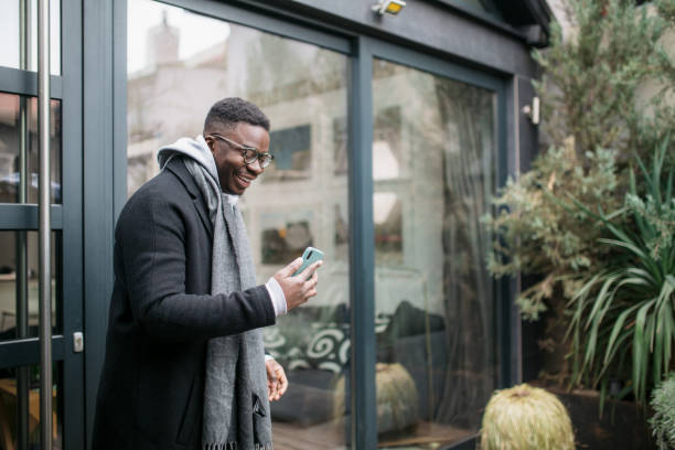 istock Happy African American young man using a smart phone 1306004864