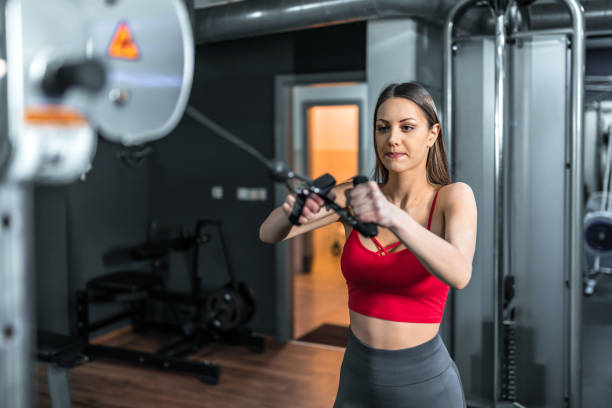 istock Young fit woman doing exercise in a crossover exercise machine. 1306007064