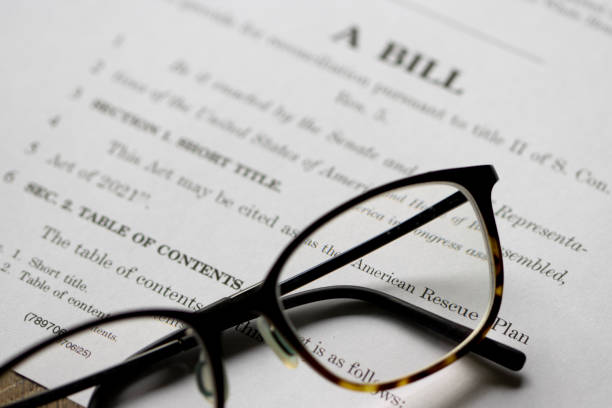American Rescue Plan Act of 2021 Closeup of the documents of the American Rescue Plan Act of 2021, a $1.9 trillion economic stimulus package proposed by President Biden to speed up the recovery. legislation stock pictures, royalty-free photos & images
