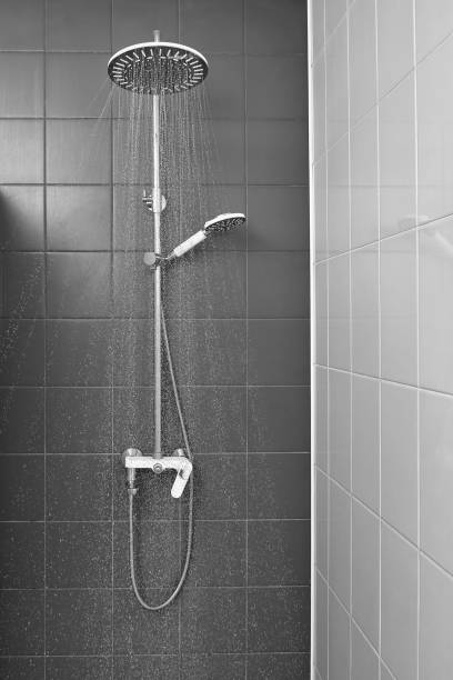 istock water flows from the shower in bathroom 1306008358