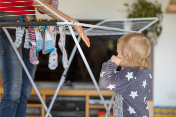 istock Cue little boy helps with hanging socks at home. 1306008519
