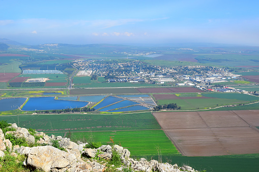 nature view on Jezreel Valley ( Valley of Megiddo ) from Mount Gilboa. plowed land, colorful fields, fish ponds. Lower Galilee region in Israel
