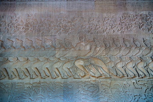 Angkor Wat, Cambodia - January 20, 2020: Churning Sea of Milk bas relief at Angkor Wat temple. The Angkor Wat is a Hindu temple complex in Cambodia and is the largest religious monument in the world.