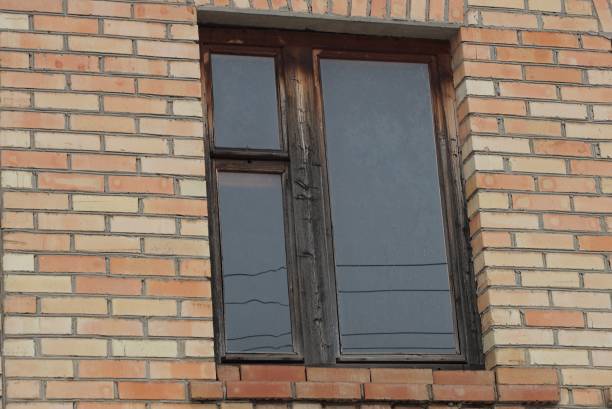 istock one big wooden old window on brown brick wall 1306009400