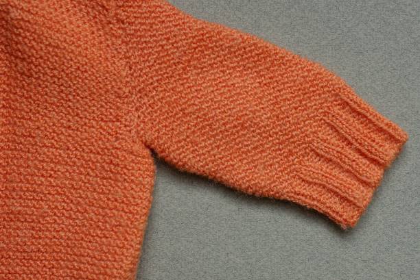 istock piece of orange small wool knitted sweater 1306009478