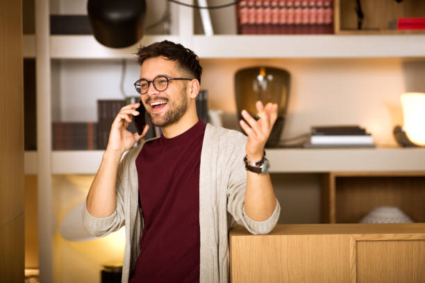 istock Young male standing and typing message on the phone 1306009702