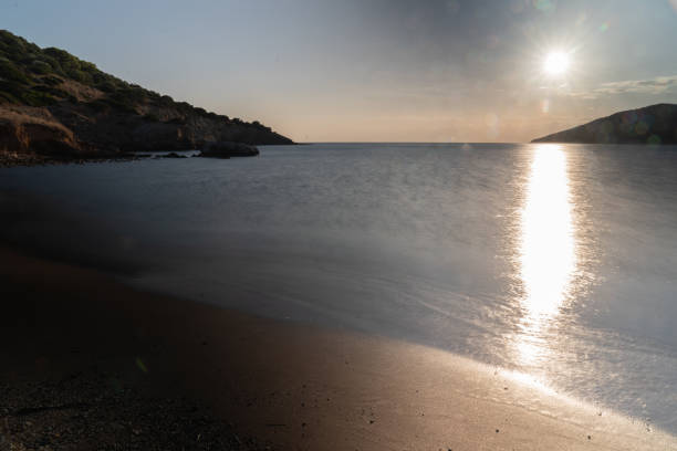istock Sandy coast against the sea and the setting sun. 1306010689