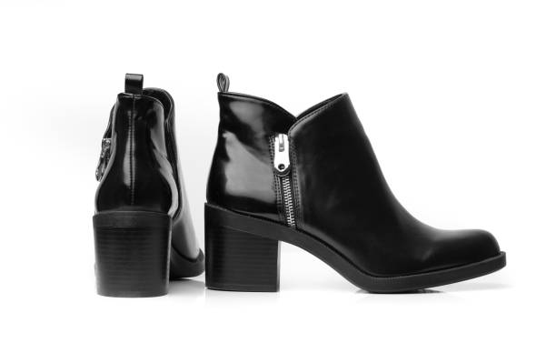 Girl's leg with black boots on a high heel. Street style.