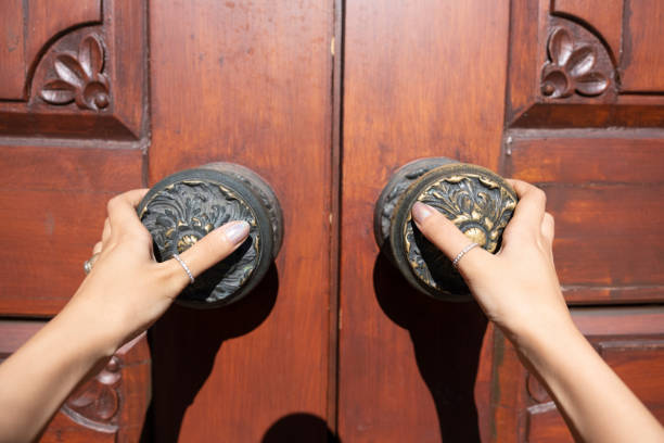 old wooden door and young woman's hands