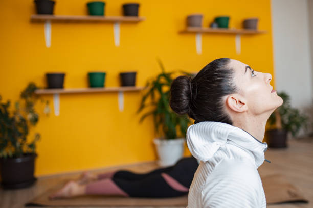 istock Two female friends practicing cobra yoga pose 1306015186