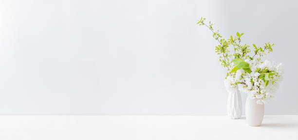 istock Home interior with easter decor. Spring flowers in a vase on a light background 1306019000
