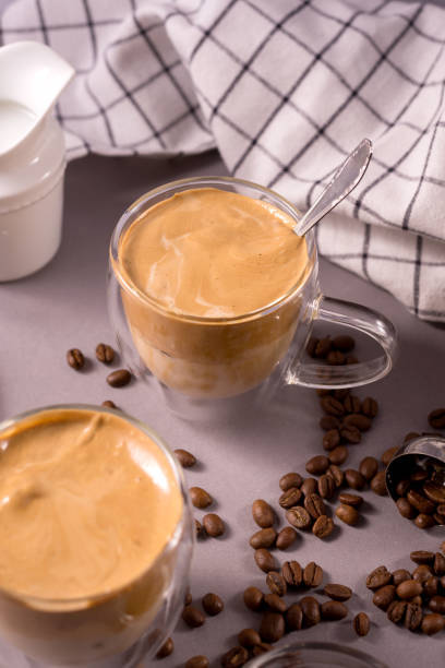 istock Dalgona Coffee. Whipped icing drink with instant coffee popular in Korea Creamy cocktailin a transparent double wall glass mug. 1306020854