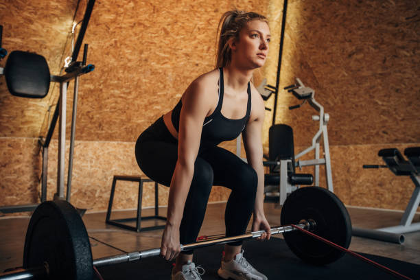 istock Woman training with weights in gym 1306021056