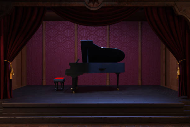 Grand piano on a night club stage with red curtains.