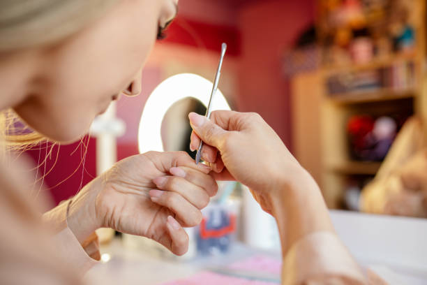 istock Woman doing her own manicure at home 1306023933