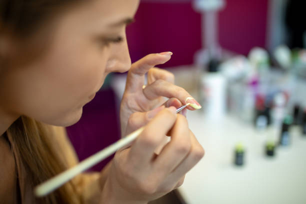 istock Woman doing her own manicure at home 1306025092