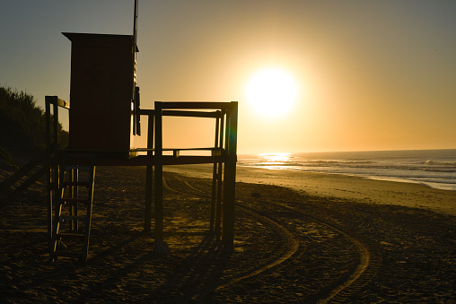 lifeguard cabin on the shores of a beach during sunrise