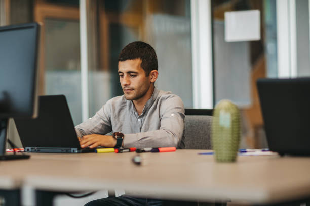 istock Young businessman working in modern office 1306025174