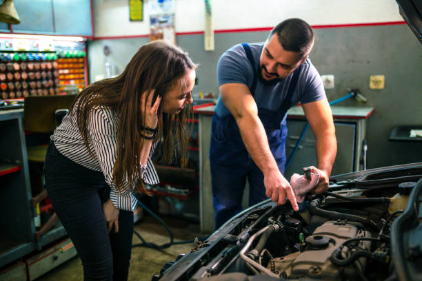 istock Auto mechanic and female customer in garage 1306026076