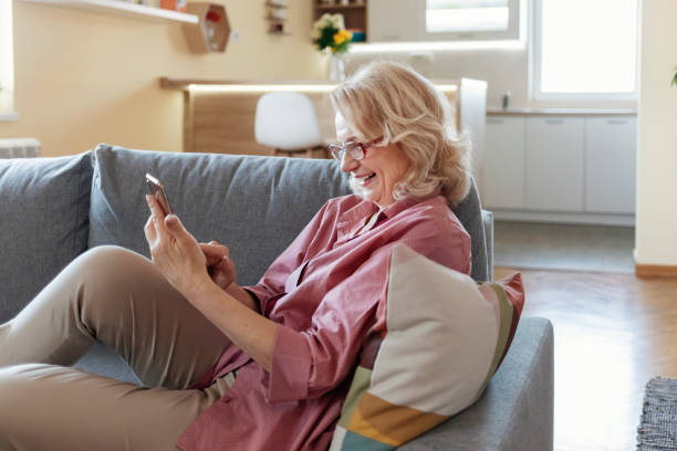 istock Elderly Woman Holding a Smartphone 1306026206