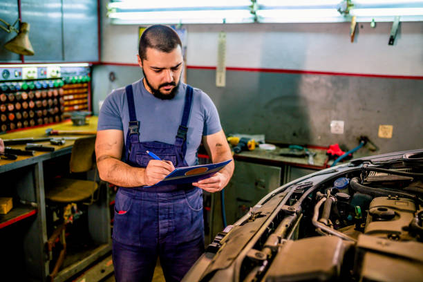 istock Mechanic working on reports in a repair shop 1306026316