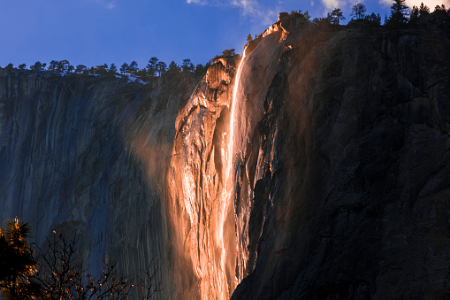 The horsetail waterfall in Yosemite National Park in California as the Fire Fall during winter. The natural Firefall is one of Yosemite National Park’s most amazing spectacles. Around the second week of February, the setting sun hits Horsetail Fall at just the right angle to illuminate the upper reaches of the waterfall. And when conditions are perfect, Horsetail Fall glows orange and red at sunset.