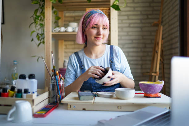Pink-haired young girl making a vlog on how to make ceramics