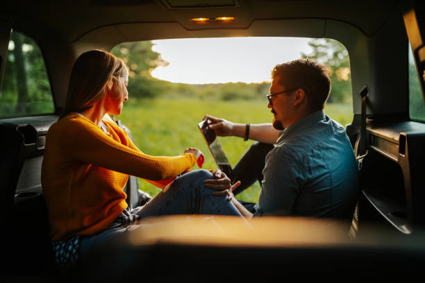 istock Loving couple using digital tablet in car 1306027197