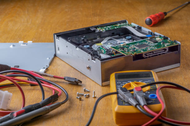 istock repair of a DVD player. Multimeter, screwdriver and cables 1306028444