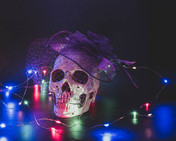 istock Fake skull with vintage purple hat and dark background. 1306028529