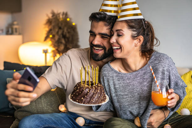 istock Romantic couple with a birthday cake, having a celebration 1306030348