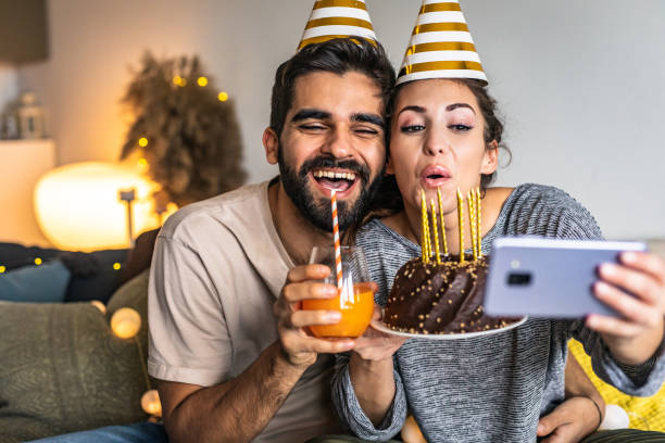 istock Romantic couple with a birthday cake, having a celebration 1306030450