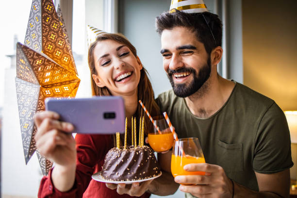 istock Romantic couple with a birthday cake, having a celebration 1306032378